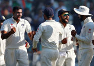 Cricket - India v England - Fourth Test cricket match - Wankhede Stadium, Mumbai - 12/12/16. India's Ravichandran Ashwin (L) and Virat Kohli (2nd R) celebrate the wicket of England's Jonny Bairstow. REUTERS/Danish Siddiqui