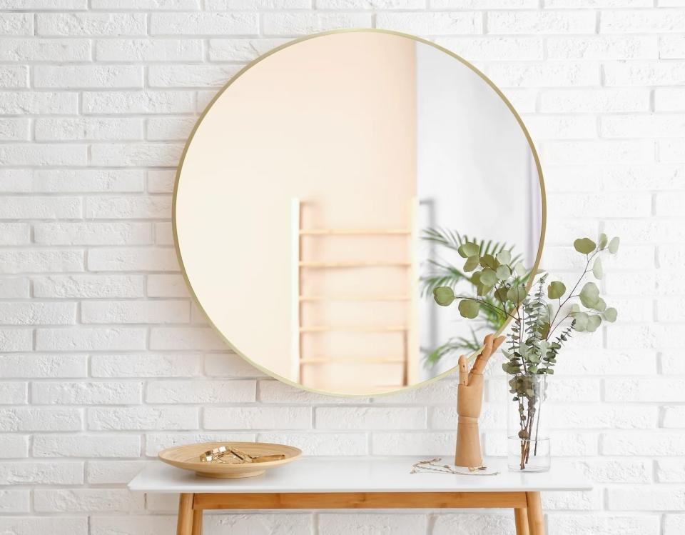 round wall mirror with gold trim