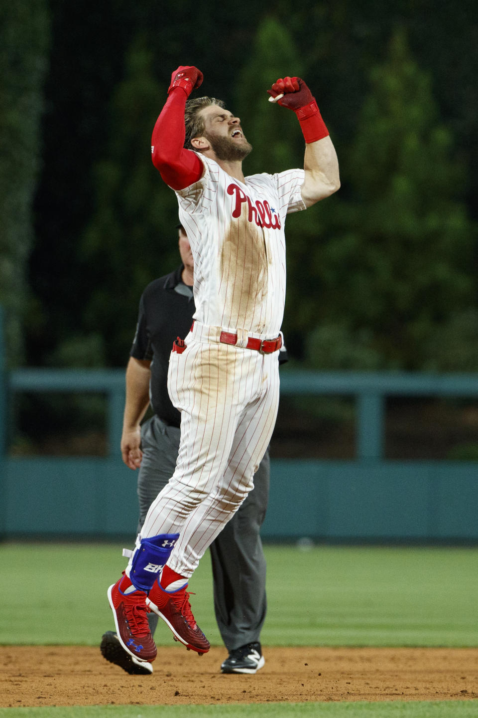 Philadelphia Phillies' Bryce Harper celebrates after hitting a game-winning two-run double off Los Angeles Dodgers relief pitcher Kenley Jansen during the ninth inning of a baseball game Tuesday, July 16, 2019, in Philadelphia. Philadelphia won 9-8. (AP Photo/Matt Slocum)