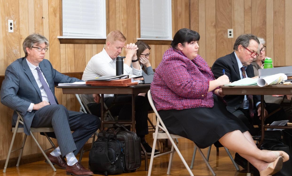 Surrounded by attorneys and witnesses from both sides, Matt Seyler, president of Prospect Hill Cemetery, second from left, awaits a decision by the Manchester Township Zoning Board after two days and over eight hours of testimony, cross examination and public comment.