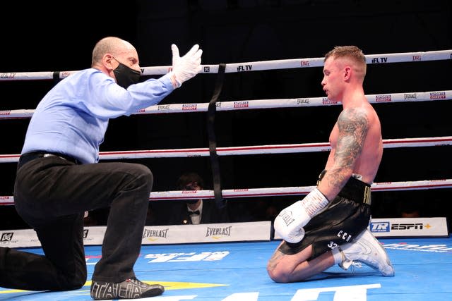 Carl Frampton is knocked down for a second time in his WBO super-featherweight title fight with Jamal Herring in Dubai and later announced his retirement 