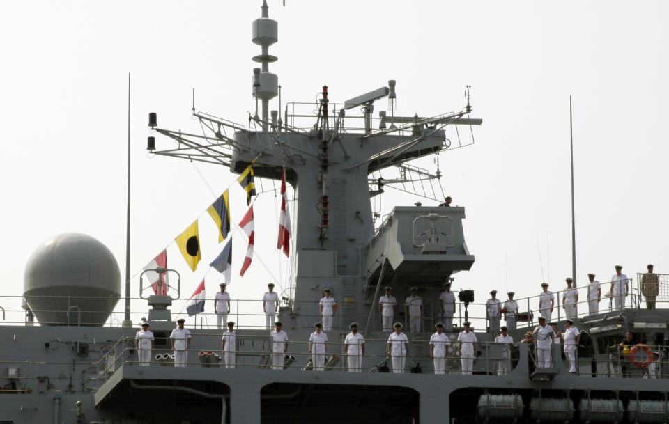 FILE - In this Aug. 3, 2018, file photo, sailors of British Royal Navy's HMS Albion amphibious assault ship man the rails upon arrival at a dock in Tokyo. China denounced the passage of the British warship HMS Albion close to Chinese-claimed islands in the South China Sea’s Paracel group, in a development that could affect negotiations on a post-Brexit trade agreement between the sides. The Albion reportedly passed by the islands on Aug. 31, 2018 while sailing from Japan to Vietnam. (AP Photo/Ken Moritsugu, File)