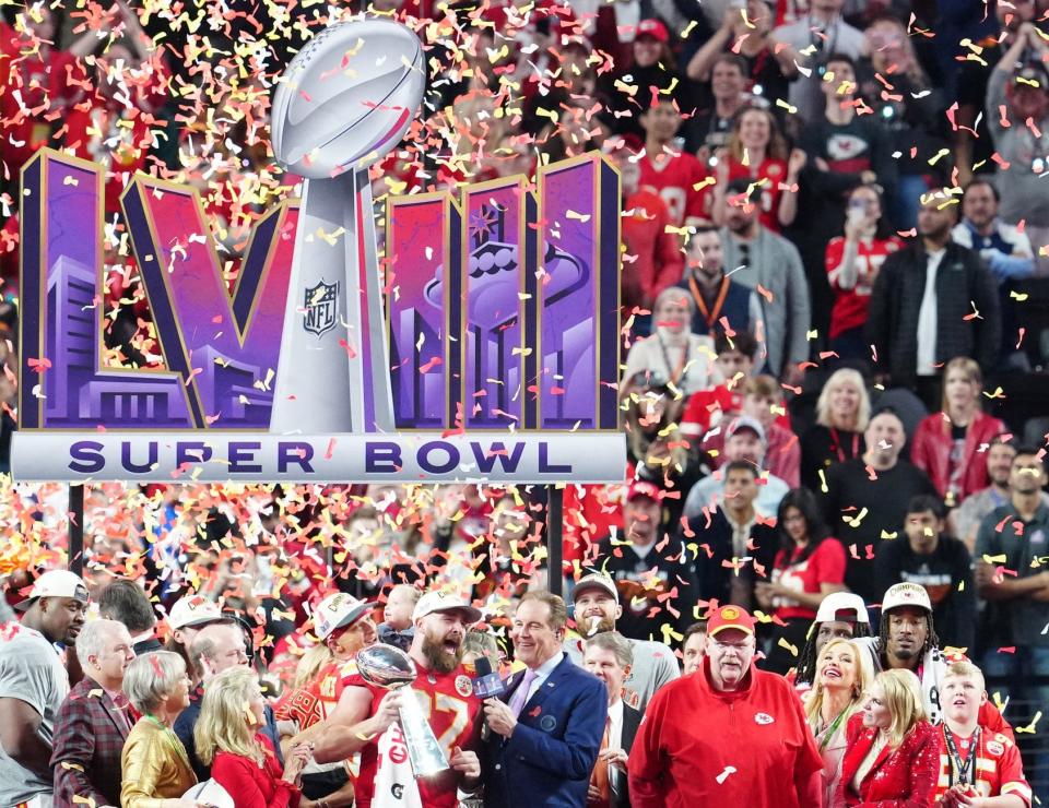 Chiefs tight end Travis Kelce celebrates with the Vince Lombardi Trophy after Sunday's overtime victory over the 49ers in Super Bowl 58.