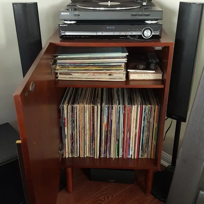 Reviewer's photo of the record cabinet, open and displaying tons of records stored inside