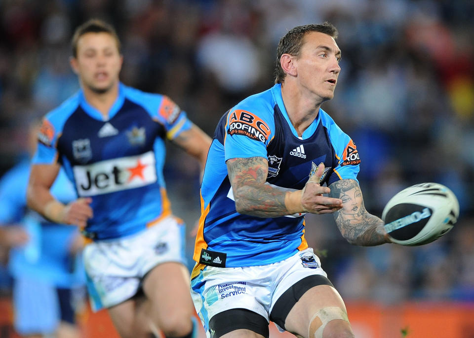 GOLD COAST, AUSTRALIA - AUGUST 14:  Mat Rogers of the Titans passes the ball during the round 23 NRL match between the Gold Coast Titans and the North Queensland Cowboys at Skilled Park on August 14, 2010 on the Gold Coast, Australia.  (Photo by Matt Roberts/Getty Images)