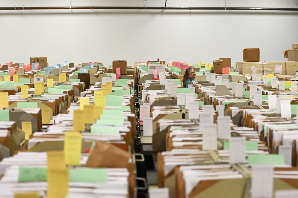 OGDEN, UTAH - MARCH 31: An IRS employee walks through tax documents in the staging warehouse at a Internal Revenue Service facility on March 31, 2022 in Ogden, Utah. (Photo by Alex Goodlett for The Washington Post via Getty Images)