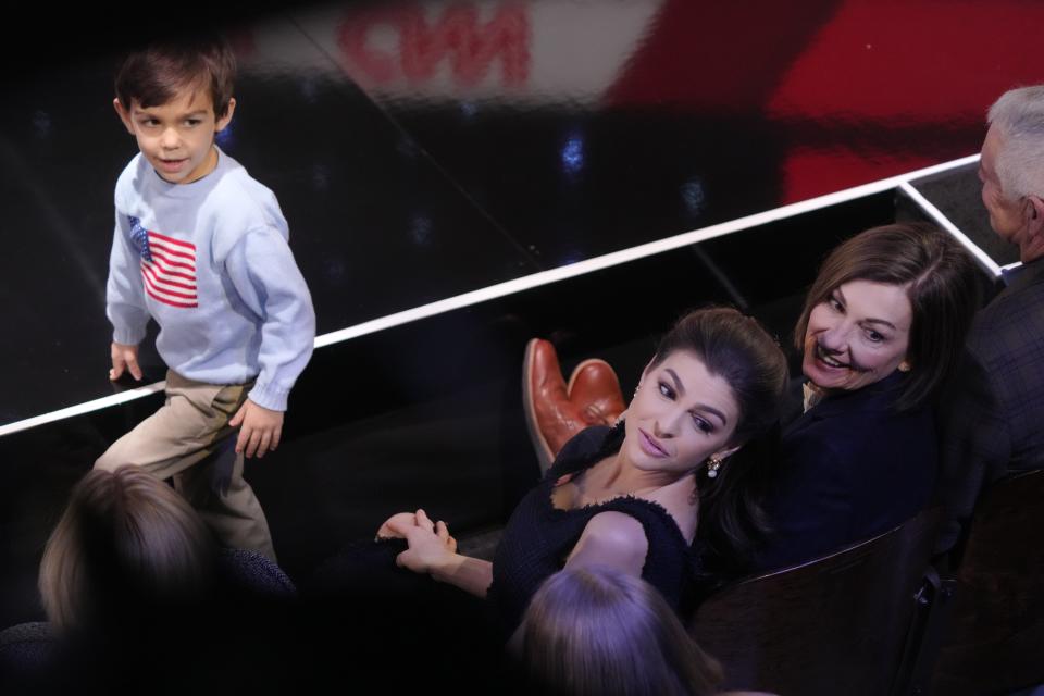 Casey DeSantis, wife of Republican presidential candidate Florida Governor Ron DeSantis, center, and Iowa Governor Kim Reynolds, right are seen seated in the front row ahead of the Republican Presidential Primary Debate at Drake University in Des Moines, Iowa hosted by CNN on Jan 10, 2024. The DeSantisÕ son Mason DeSantis is seen standing.