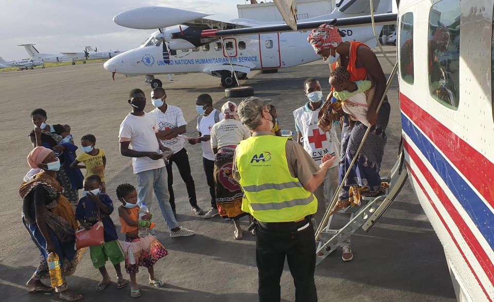 People fleeing fighting between insurgents and government forces in and around the northern Mozambican town of Palma arrive after being evacuated by plane to the Cabo Delgado provincial capital of Pemba, Mozambique, Thursday April 1, 2021. They were just a few of the thousands of residents who have fled to nearby Tanzania and south to the provincial capital of Pemba, according to international aid agencies. (Dave LePoidevin, MAF via AP)