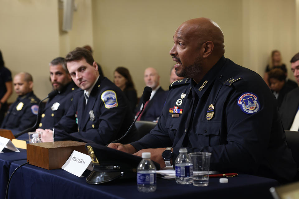 MPD officer Daniel Hodges, center, listens while Harry Dunn, private first class with the U.S. Capitol Police, speaks during the hearing. (Jim Lo Scalzo/EPA/Bloomberg via Getty Images)