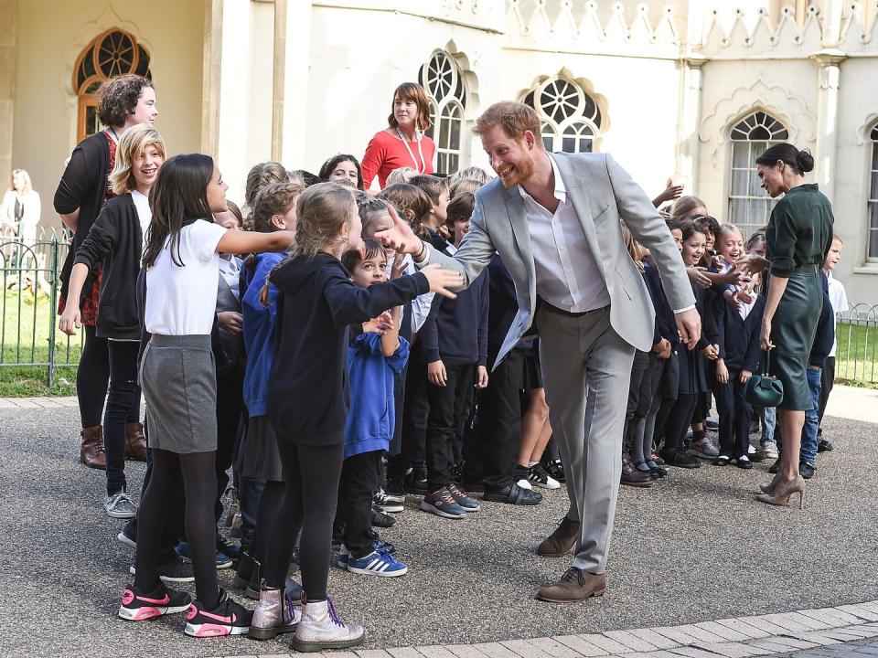 <p>Harry and Meghan talk to school children during a visit to Sussex in October 2018.</p>