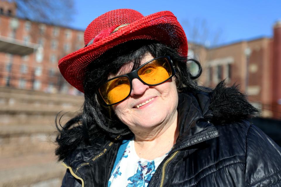 Audrey Burnett fashions one of her many wigs at Henry Law Park on Jan. 24, 2022 in Dover.