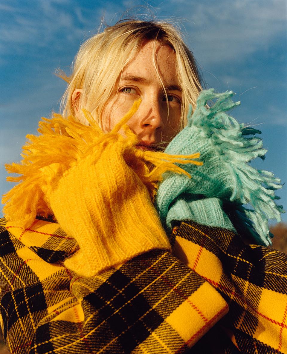 “I was very lucky that I had a proper protector with me,” Ronan says of her mother’s presence on set and the hazards of the industry that the #MeToo movement has highlighted. Here, she bundles up in a plaid Michael Kors Collection coat and Miu Miu scarves.