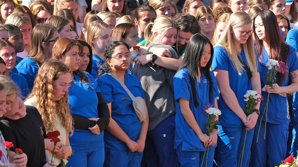 Augusta University students, in blue, and University of Georgia students gather on the UGA campus to pay tribute to Laken Riley. - Nell Carroll/Atlanta Journal-Constitution via AP