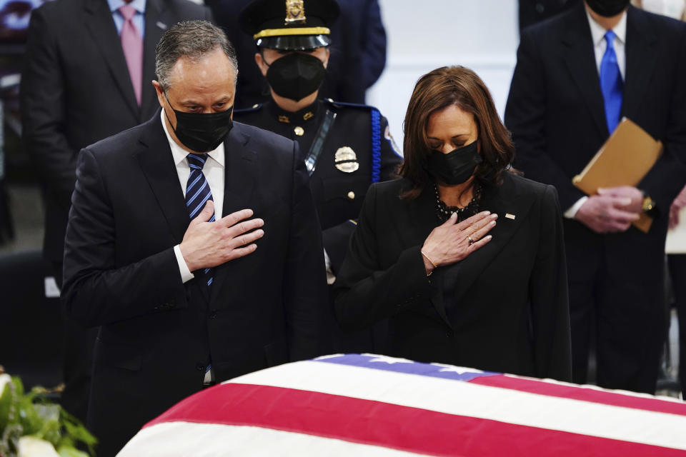 Vice President Kamala Harris and her husband Doug Emhoff, at the casket of former Sen. Bob Dole of Kansas, as he lies in state in the Rotunda of the U.S. Capitol, Thursday, Dec. 9, 2021 in Washington. (Shawn Thew/Pool via AP)