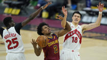 Cleveland Cavaliers' Collin Sexton (2) drives between Toronto Raptors' Yuta Watanabe (18) and Chris Boucher (25) in the first half of an NBA basketball game, Saturday, April 10, 2021, in Cleveland. (AP Photo/Tony Dejak)