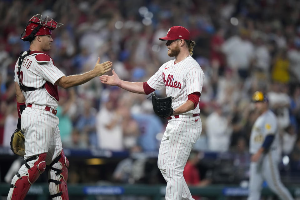 Philadelphia Phillies catcher J.T. Realmuto, left, and pitcher Craig Kimbrel celebrate after the Phillies won a baseball game against the Milwaukee Brewers, Tuesday, July 18, 2023, in Philadelphia. (AP Photo/Matt Slocum)