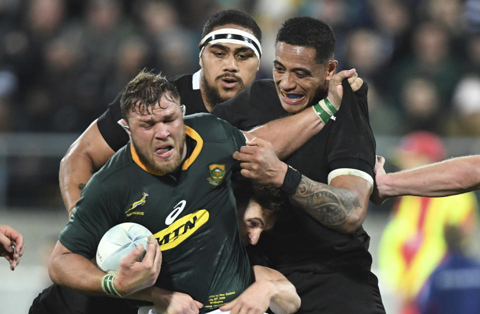 South Africa's Duane Vermeulen, left, is held in a tackle by New Zealand's Shannon Frizell during a Rugby Championship match between the All Blacks and South Africa in Wellington, New Zealand, Saturday, July 27, 2019. (AP Photo/Ross Setford)