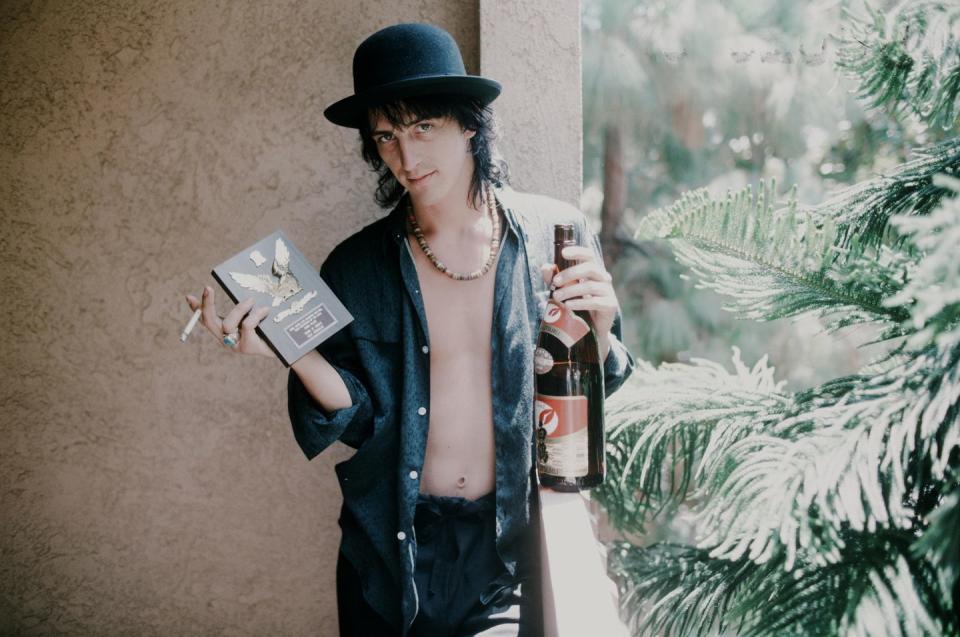 izzy stradlin guns n roses holding shield for ml popularity vote and sake at a hotel