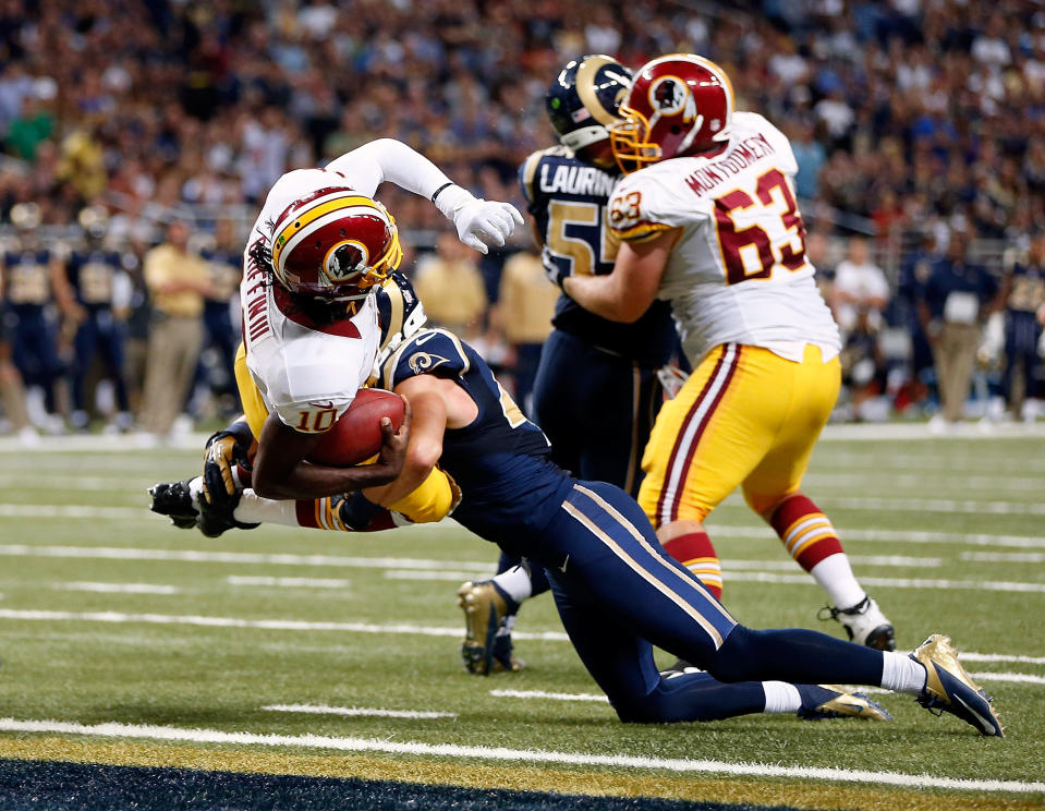 Quarterback Robert Griffin III #10 of the Washington Redskins lunges over the goal line for a touchdown as strong safety Craig Dahl #43 of the St. Louis Rams defends during the game against the St. Louis Rams at Edward Jones Dome on September 16, 2012 in St Louis, Missouri. (Photo by Jamie Squire/Getty Images)