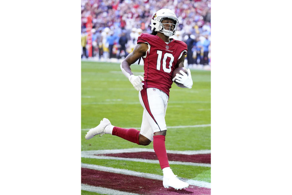 FILE - Arizona Cardinals wide receiver DeAndre Hopkins (10) scores a touchdown against the Los Angeles Chargers during the first half of an NFL football game in Glendale, Ariz., Sunday, Nov. 27, 2022. DeAndre Hopkins and Dalvin Cook lead a list of accomplished players who are still available a week before several NFL teams open training camp. (AP Photo/Ross D. Franklin, File)