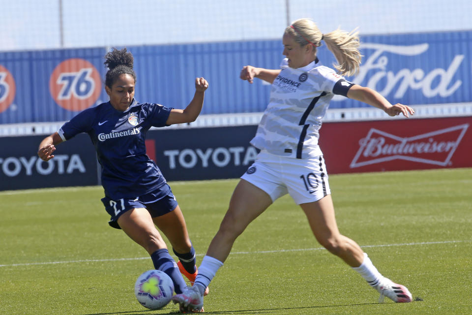 North Carolina Courage defender Addisyn Merrick (27) battles for the ball with Portland Thorns FC midfielder Lindsey Horan (10) during the first half of an NWSL Challenge Cup soccer match at Zions Bank Stadium Saturday, June 27, 2020, in Herriman, Utah. (AP Photo/Rick Bowmer)