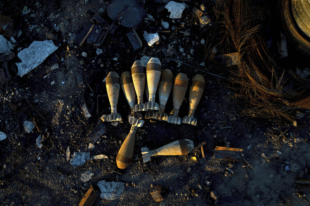 Burned mortar shells lie on the ground in the recently retaken area of Kamyanka, Ukraine, Monday, Sept. 19, 2022. Residents of Izium, a city recaptured in a recent Ukrainian counteroffensive that swept through the Kharkiv region, are emerging from the confusion and trauma of six months of Russian occupation, the brutality of which gained worldwide attention last week after the discovery of one of the world's largest mass grave sites. (AP Photo/Evgeniy Maloletka)