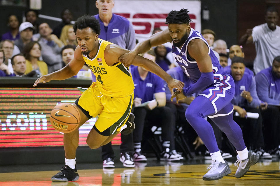 TCU guard Mike Miles Jr. (1) and Baylor guard LJ Cryer (4) chase the ball during the first half of an NCAA college basketball game in Waco, Texas, Wednesday, Jan. 4, 2023. (AP Photo/LM Otero)