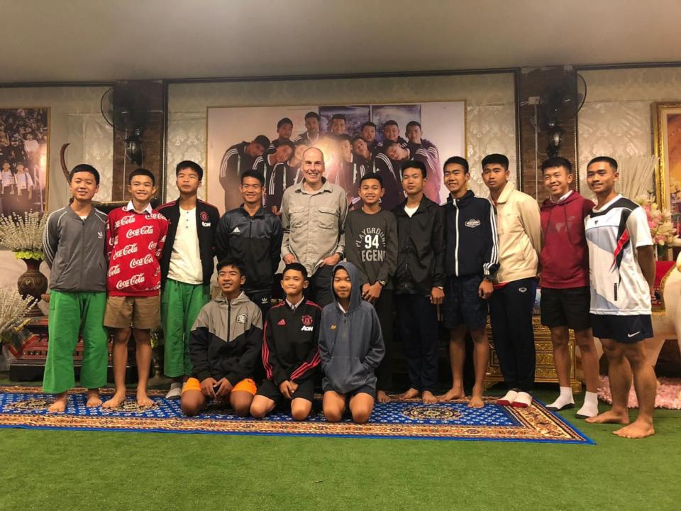 PHOTO: Thai cave rescuer Rick Stanton, center, stands with the the Wild Boars soccer team. (Courtesy of Rick Stanton)
