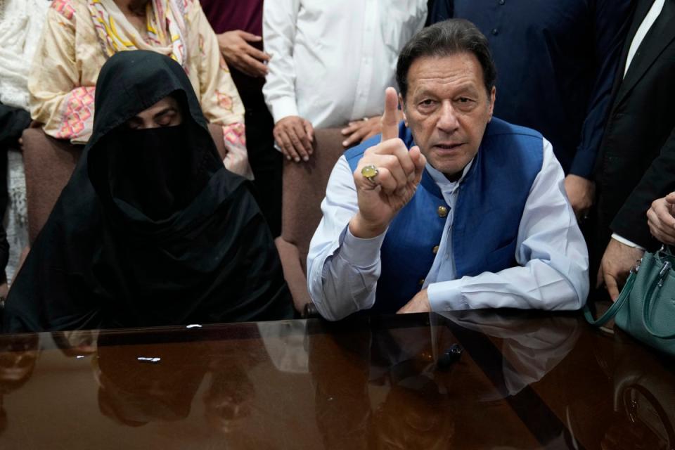 Imran Khan talks to the media before signing documents to submit surety bond over his bails in different cases, at an office of Lahore High Court in Lahore, Pakistan, in 2023 (AP)