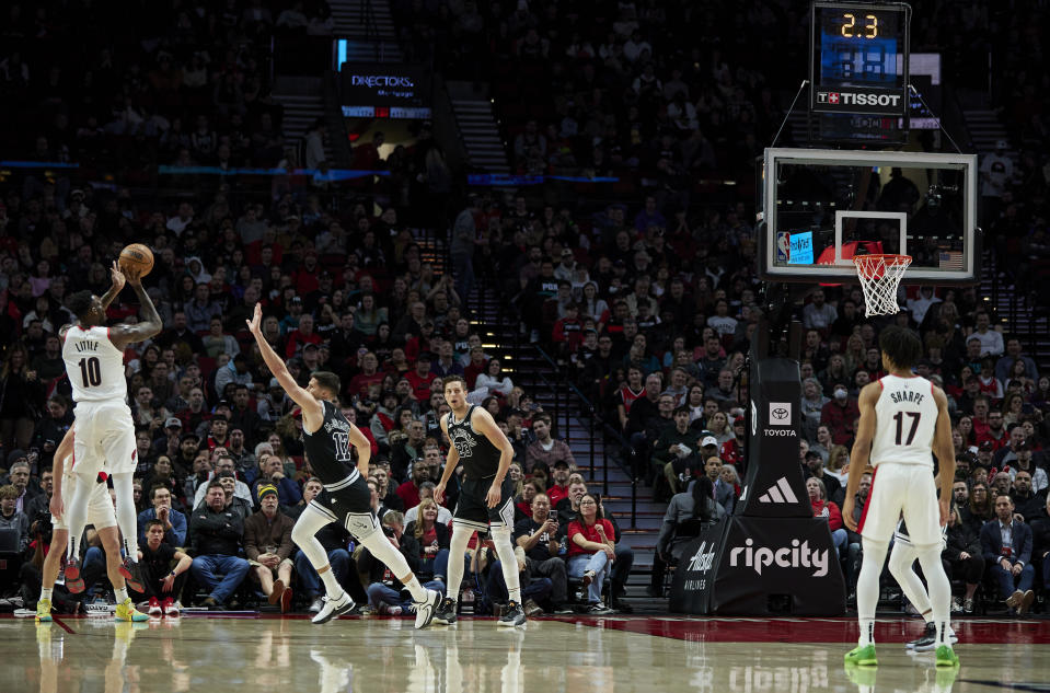 Portland Trail Blazers forward Nassir Little, left, shoots a 3-point basket over San Antonio Spurs forward Doug McDermott during the first half of an NBA basketball game in Portland, Ore., Monday, Jan. 23, 2023. (AP Photo/Craig Mitchelldyer)