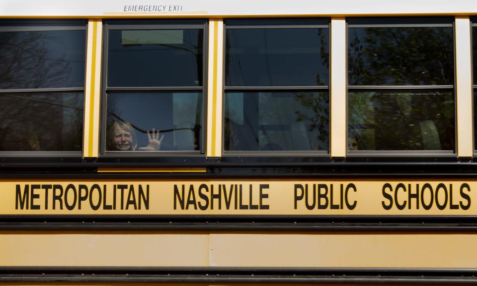 A child weeps while on a bus used for evacuation from The Covenant School, where a mass shooting killed six people, including three children and three school staff members in Nashville, Tenn.