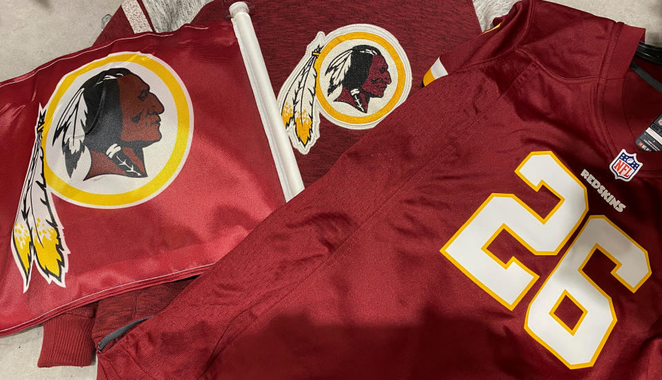 Washington Redskins football shirts and a team flag on sale at a sporting goods store in Bailey's Crossroads, Virginia, U.S., June 24, 2020.  REUTERS/Kevin Lamarque