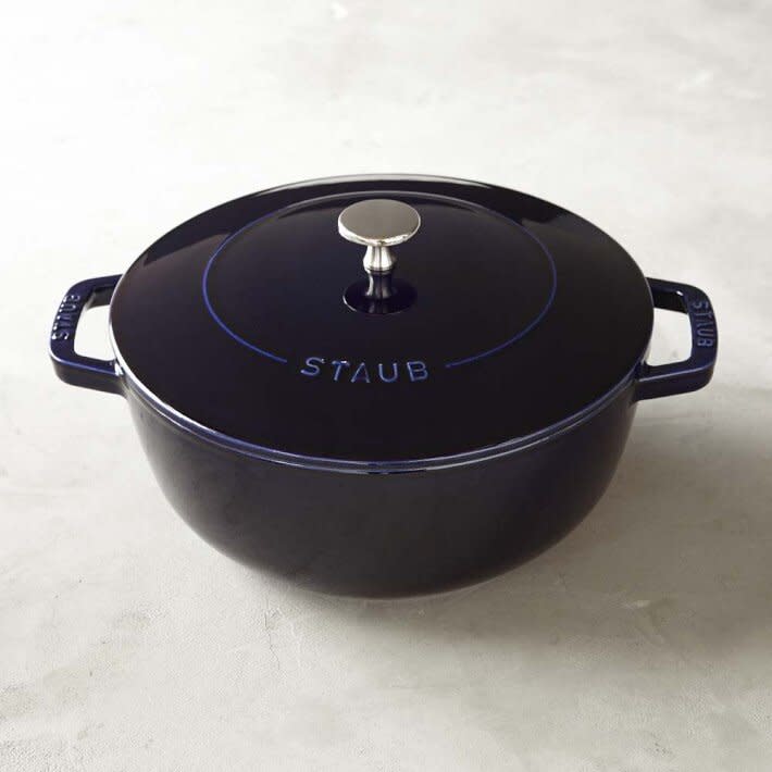dark blue pot and lid on beige counter