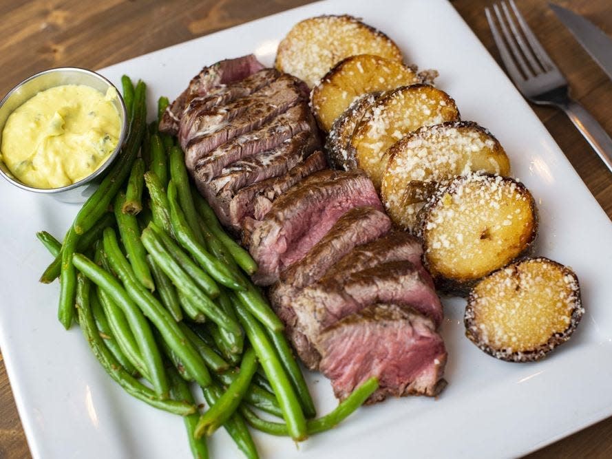 Steak, green beans, and potatoes at Theo's Steaks, Sides & Spirits.