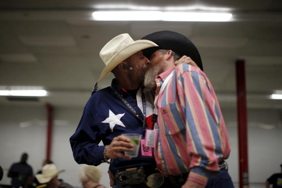 Gordon Satterly, 61, from Michigan (L) kisses his husband Richard Brand, 53, from Texas, at the International Gay Rodeo Association's Rodeo In the Rock party in Little Rock, Arkansas, United States April 24, 2015. Contestants at the International Gay Rodeo in Arkansas, a Bible Belt state with a same-sex marriage ban on its books, competed in events from barrel racing to bull riding on the soft soil of a fairground that looked like just any small-scale rodeo held throughout the United States. The U.S. Supreme Court is expected to rule in June whether to strike down bans on gay marriage nationwide. Arkansas has been one of the front-line states in the battle between cultural conservatives and those seeking expanded rights for the lesbian, gay, bisexual and transgender (LGBT) community. REUTERS/Lucy Nicholson TPX IMAGES OF THE DAY  PICTURE 26 OF 27 FOR WIDER IMAGE STORY "GAY RODEO IN LITTLE ROCK"  SEARCH "RODEO LUCY" FOR ALL IMAGES      TPX IMAGES OF THE DAY     