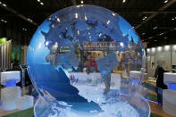 A woman looks at a World globe at the COP25 climate talks congress in Madrid, Spain, Friday, Dec. 13, 2019. Officials from almost 200 countries are scrambling to reach an agreement at a United Nations climate meeting amid growing concerns that key issues may be postponed for another year. (AP Photo/Paul White)