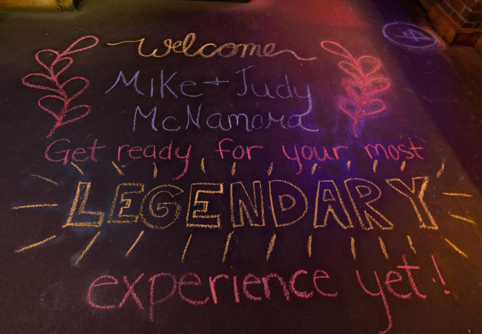 The staff at the Alliance Texas Roadhouse restaraunt chalked out a surprise welcome at the entrance for Judy and Mike McNamara.