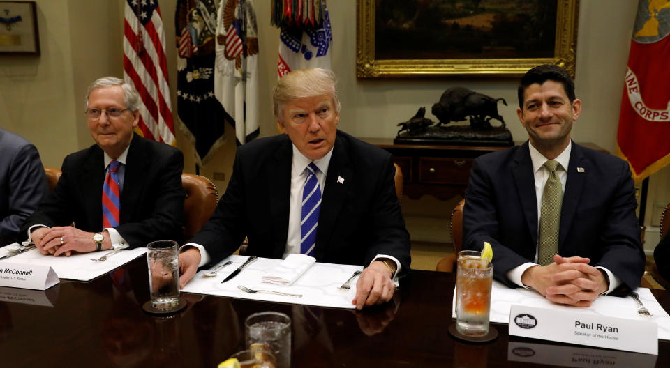 Senate Majority Leader Mitch McConnell (R-Ky.), left, and House Speaker Paul Ryan (R-Wis.), right, sit alongside President Donald Trump. Cutting taxes is a major triumph for the trio. (Photo: Kevin Lamarque / Reuters)