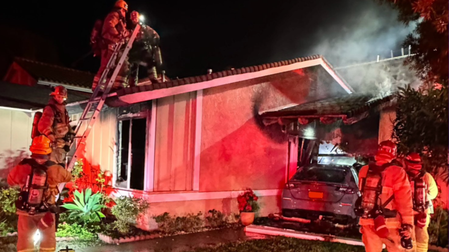 Firefighters respond after a car rammed into a home in Irvine on Jan. 8, 2024.