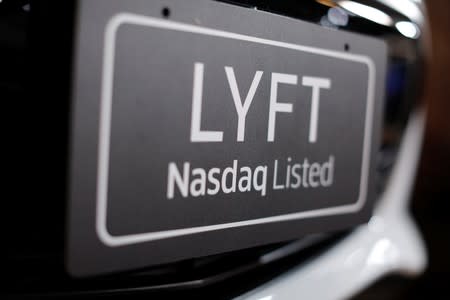 Lyft supporters gather for the Lyft IPO as the company lists its shares on the Nasdaq in the first-ever ride-hailing initial public offering, in Los Angeles