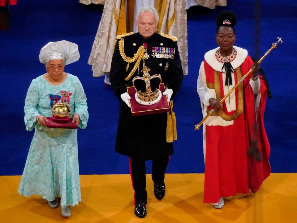 Baroness Floella Benjamin (R), carrying the the Sovereign’s Sceptre with Dove, General Sir Gordon Messenger, (C) the Governor of HM Tower of London, carrying St Edward’s Crown as Lord High Steward of England, and Dame Elizabeth Anionwu (L) (Getty Images)