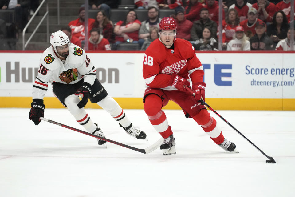 Detroit Red Wings defenseman Robert Hagg (38) protects the puck from Chicago Blackhawks left wing Jujhar Khaira (16) in the first period of an NHL hockey game Wednesday, March 8, 2023, in Detroit. (AP Photo/Paul Sancya)