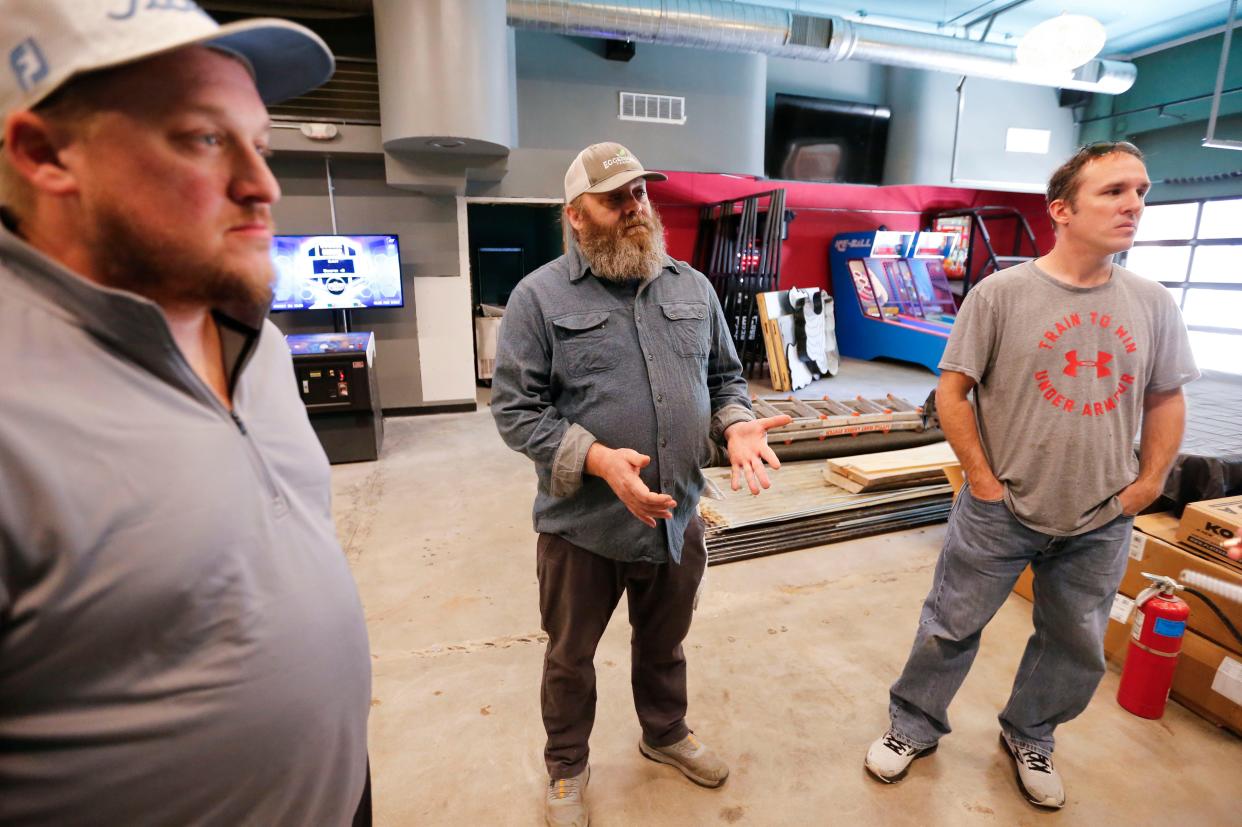 Bigg Time Arcade owners Matt Faucett (left), Collin Saddler (center), and Levi Grant talk about the new "adult-geared arcade" coming to downtown at 301 Park Central East, formerly Vintage Dance Lounge.