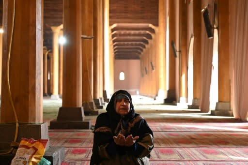 A woman prays in the main mosque in Srinagar after it opened for the first time in nearly five months