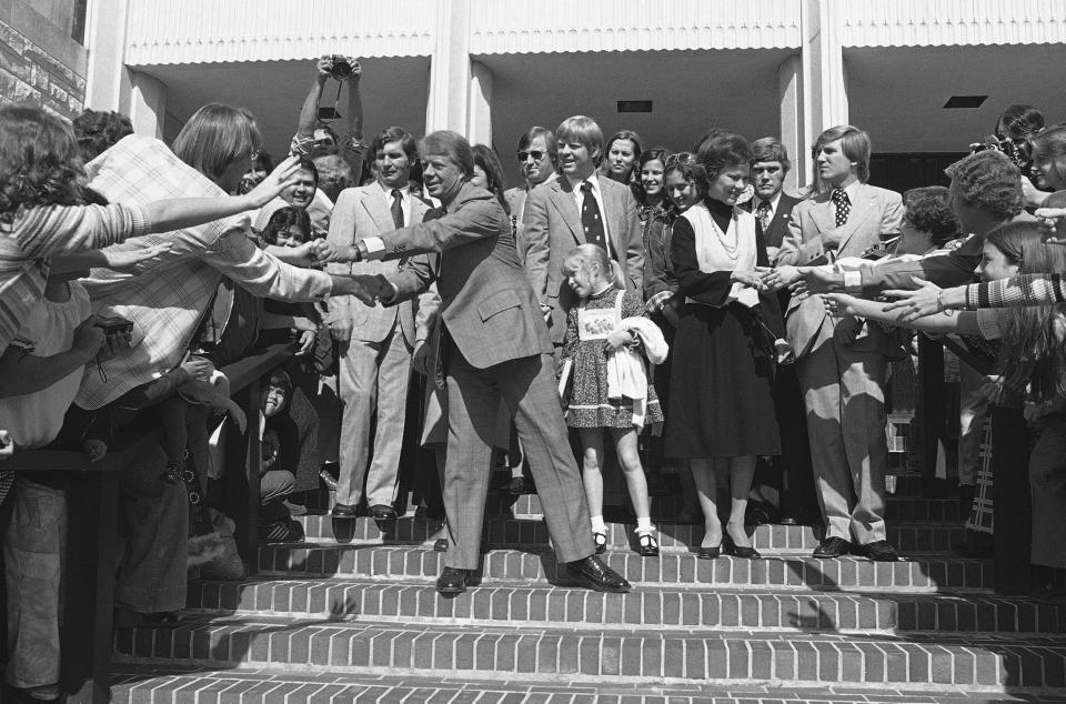 FILE - Democratic Presidential candidate Jimmy Carter and his wife, Rosalynn Carter, greet people after attending church services at the University Baptist Church in Fort Worth, Texas on Sunday, Oct. 31, 1976. At center is their daughter, Amy. Carter's Baptist faith was one of his calling cards in the 1976 presidential campaign. But it landed him in political trouble when he tried to explain his faith to Playboy magazine by discussing Biblical standards of sex and sin. (AP Photo/John Duricka, File)