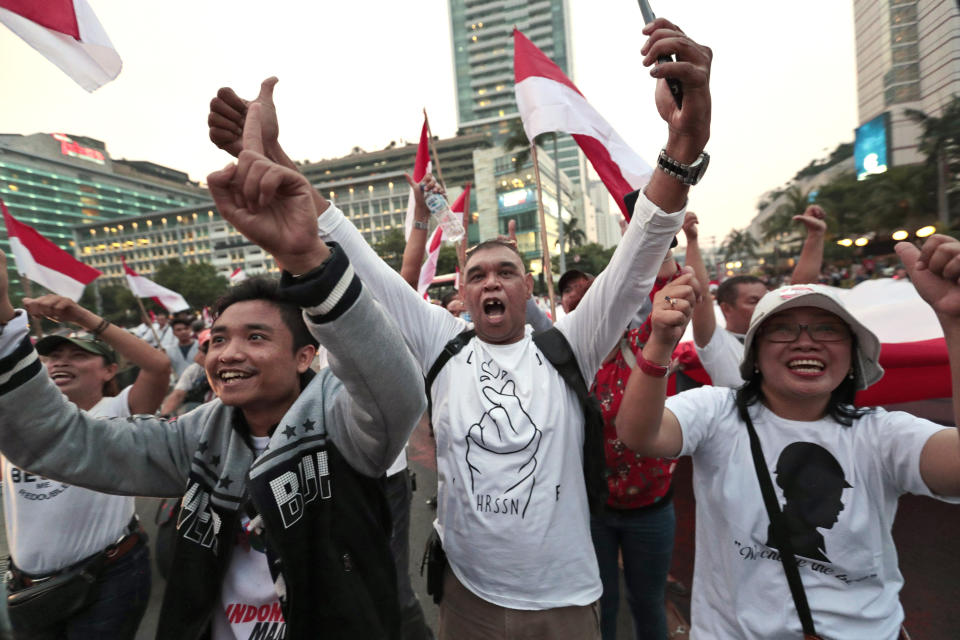 Supporters of Indonesian President Joko Widodo celebrate during a rally in Jakarta, Indonesia, Wednesday, April 17, 2019. Widodo is on track to win a second term, preliminary election results showed Wednesday, in apparent victory for moderation over the ultra-nationalistic rhetoric of his rival Prabowo Subianto. (AP Photo/Dita Alangkara)