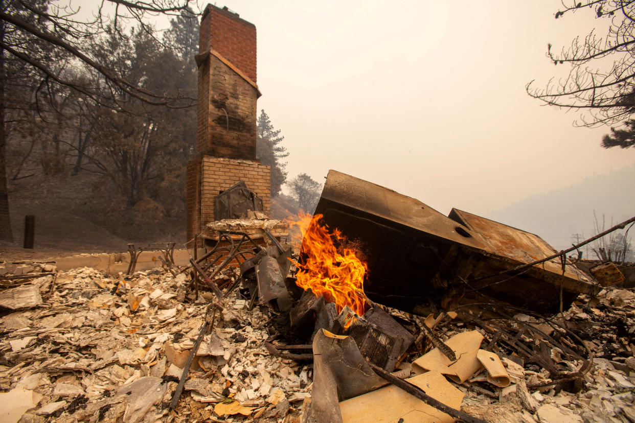 The charred remains of a home are seen in Wrightwood, Calif., on Wednesday.