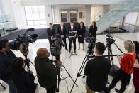 John R. Lausch Jr., U.S. Attorney for the Northern District of Illinois, center, briefs reporters on the trial of Floyd Brown in the killing of Special Deputy United States Marshal Jacob Keltner on Wednesday, March 20, 2019, U.S. District Courthouse in Rockford. Brown pleaded not guilty Wednesday to federal charges accusing him of fatally shooting Keltner, who was trying to serve an arrest warrant at a hotel. (Scott P. Yates/Rockford Register Star via AP)