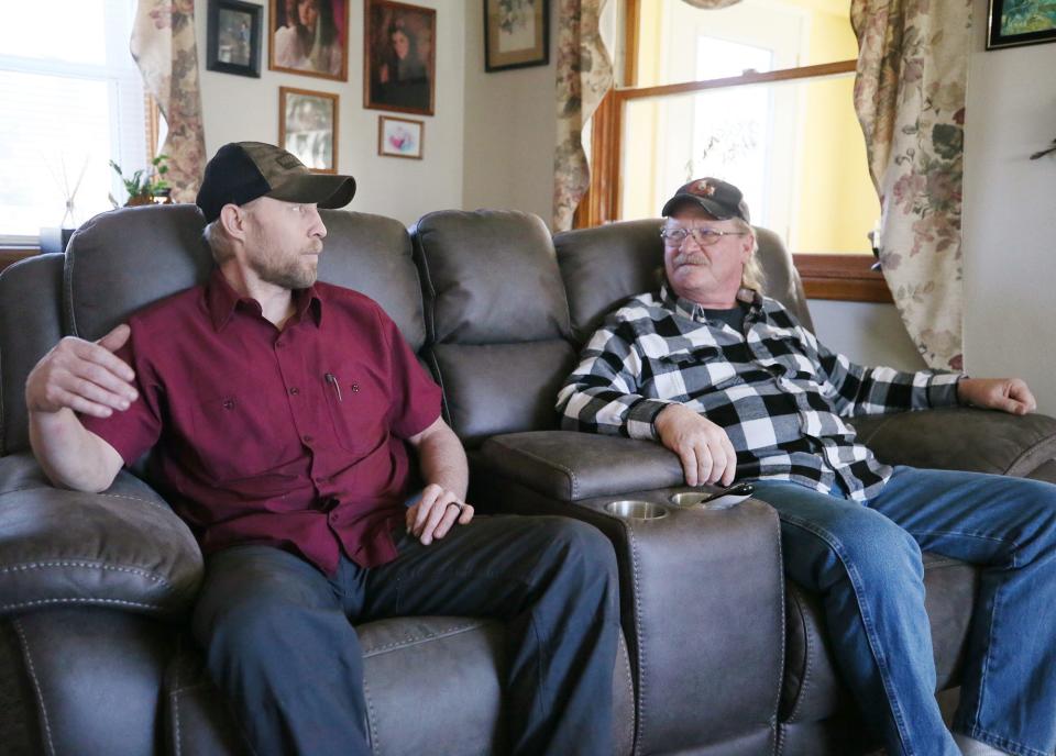 Kip Stackpole, left, and his older brother Ricky talk Monday, March 11, 2024, at Ricky Stackpole's Rootstown house about suffering heart attacks at the same time, and being hospitalized together in 2023.