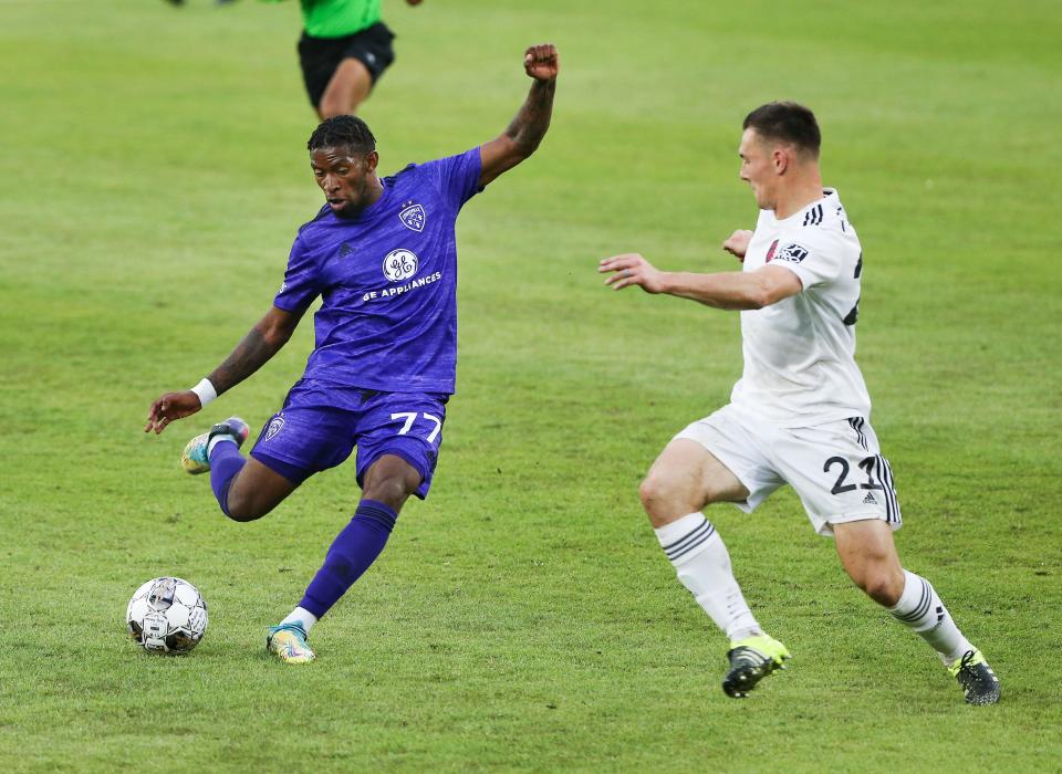 Louisville City FC's Enoch Mushagalusa (77) shoots against St. Louis City SC's Kyle Hiebert (21) during the U.S. Open Cup at the Lynn Family Stadium in Louisville, Ky. on April 20, 2022.